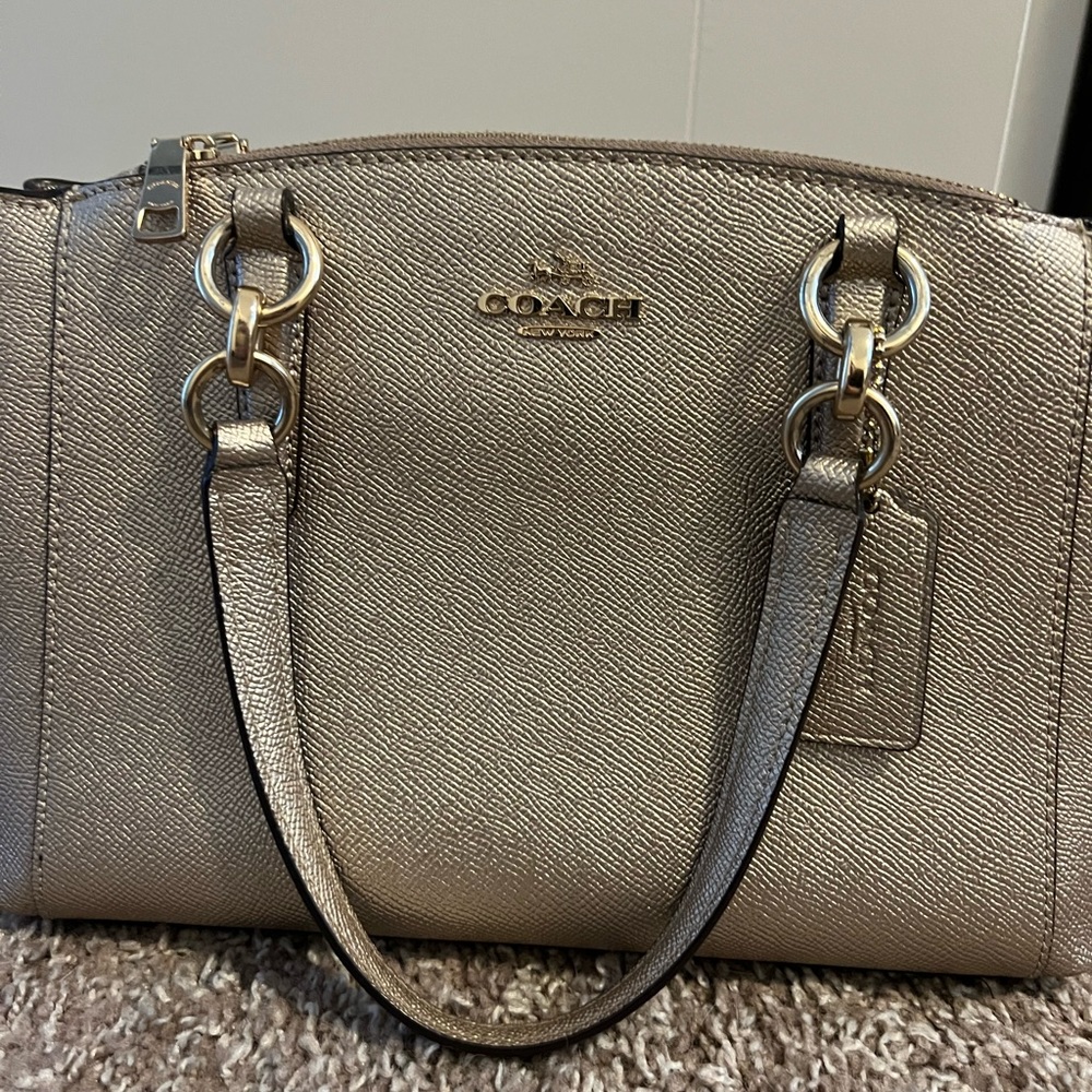 Champagne coach hand bag. Great condition.